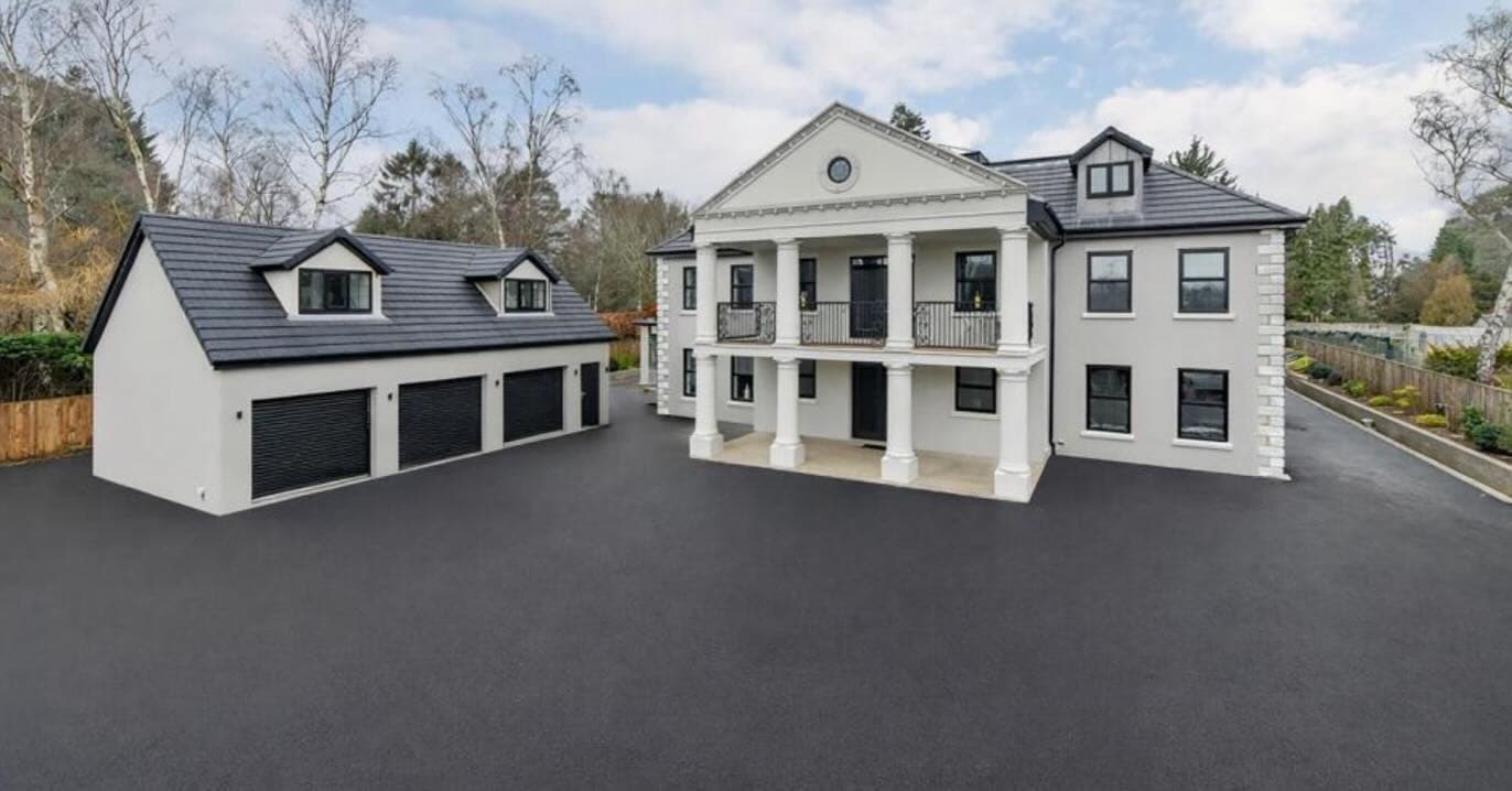 Luxury modern residential home in Newcastle at twilight with expansive glass walls