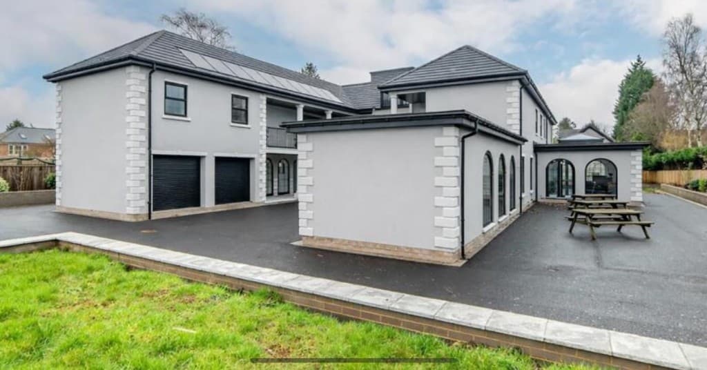 Modern residential property with slate roof tiles and solar panel installation